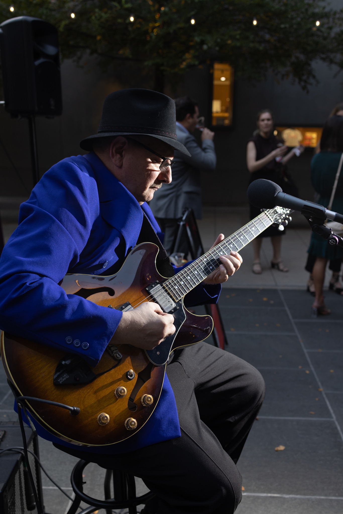 Kevin Curtis performing live with a guitar with shadow.